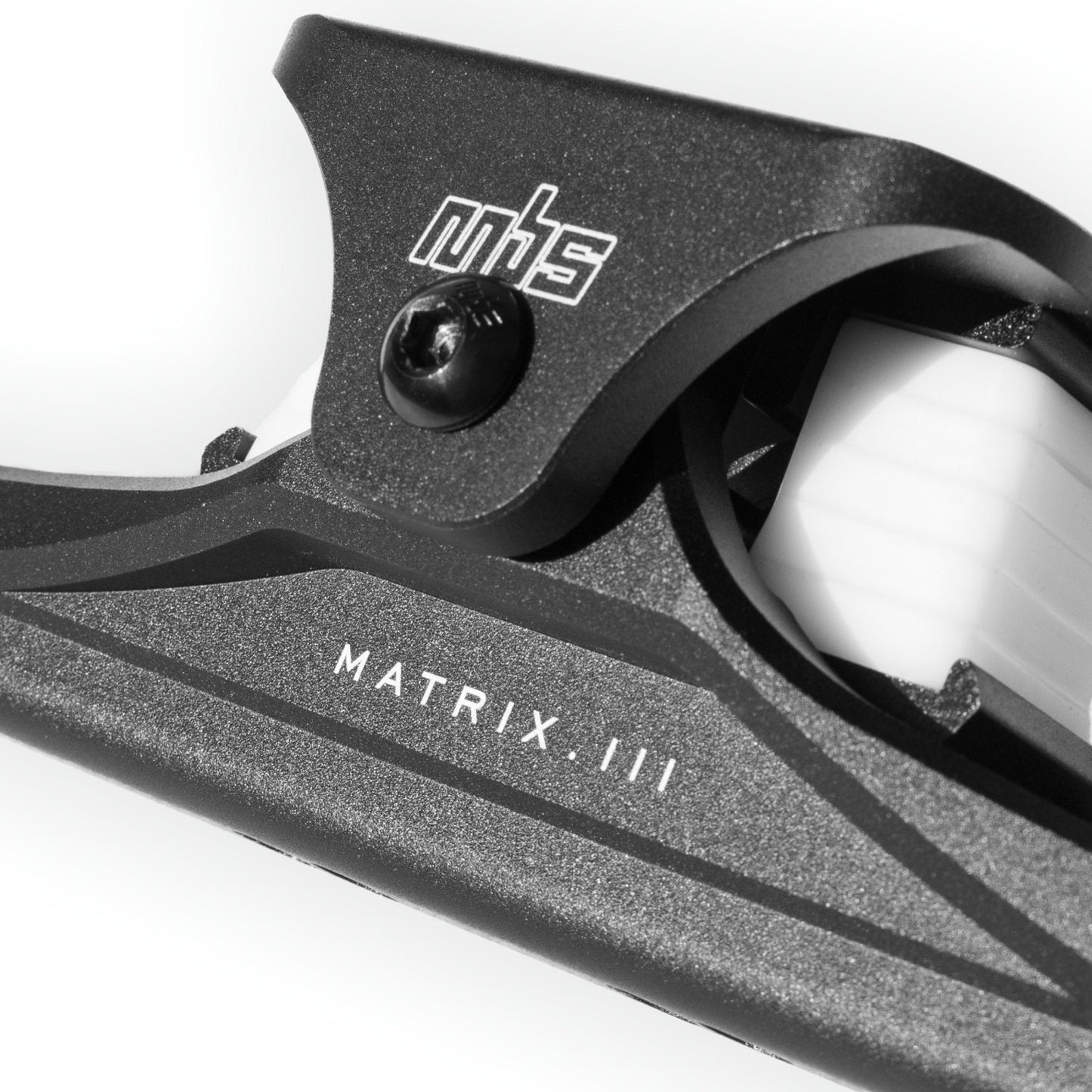 Close-up of MBS Matrix III CNC truck's wide top truck and adjustable shock block positions.