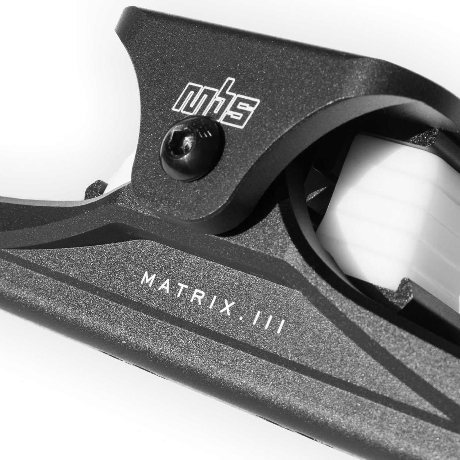 Close-up of MBS Matrix III CNC truck's wide top truck and adjustable shock block positions.